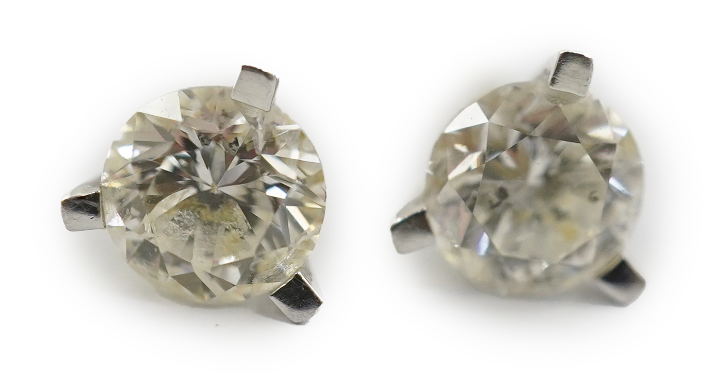 A modern pair of 18ct white gold and solitaire diamond set ear studs